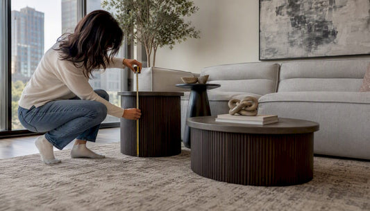 Various side tables beside sofa showing height differences
