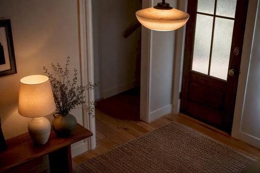 Warmly lit elegant entryway with layered lamps