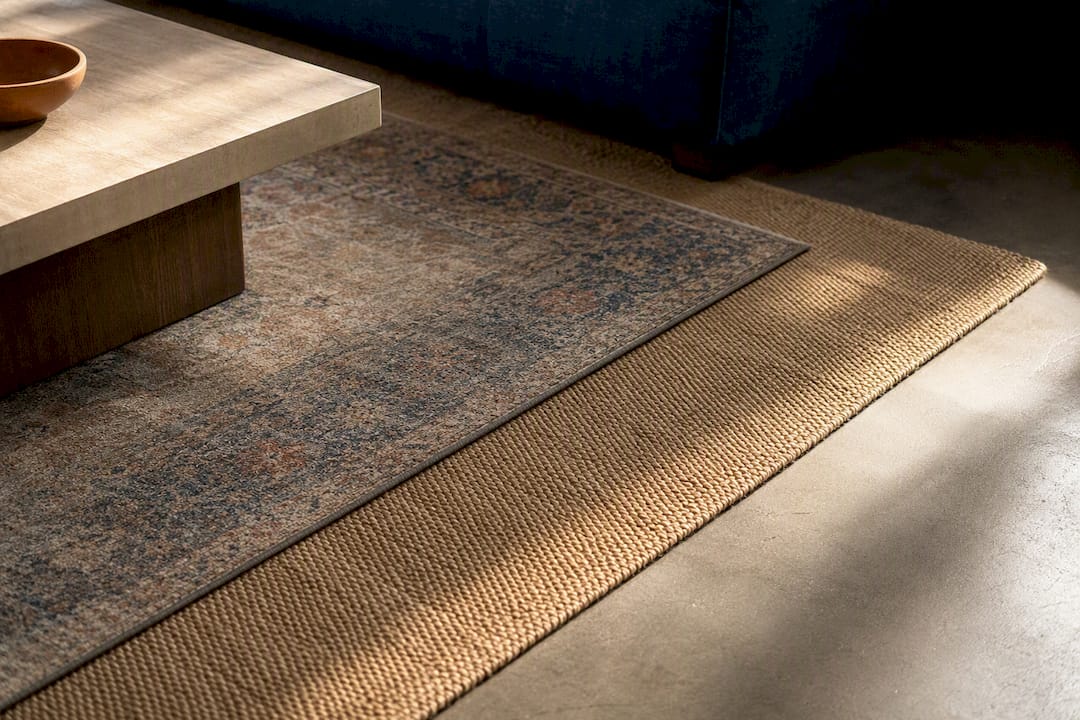 Layered rugs with visible base border
