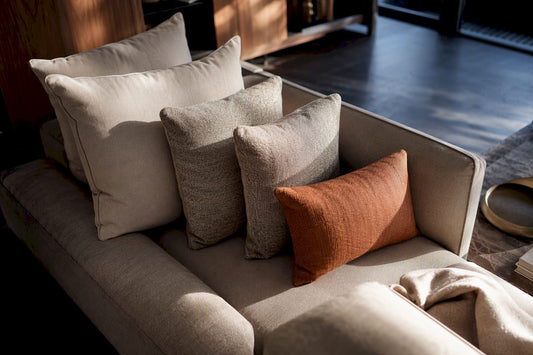 Layered five-pillow sofa arrangement