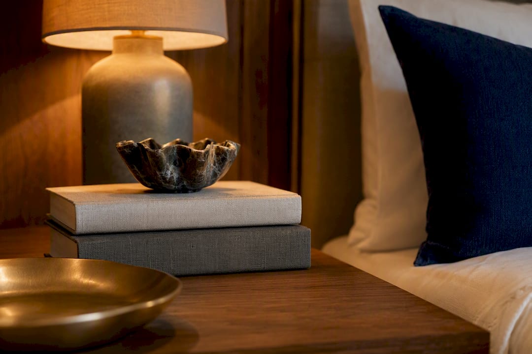 Tiered bedside table arrangement in modern bedroom