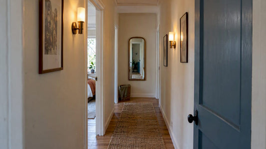 Narrow hallway with spaced wall sconces