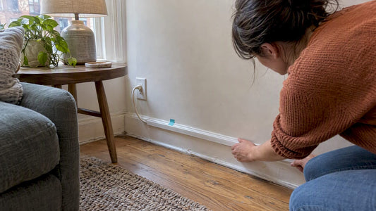 Removable raceway guiding a lamp cord along baseboard