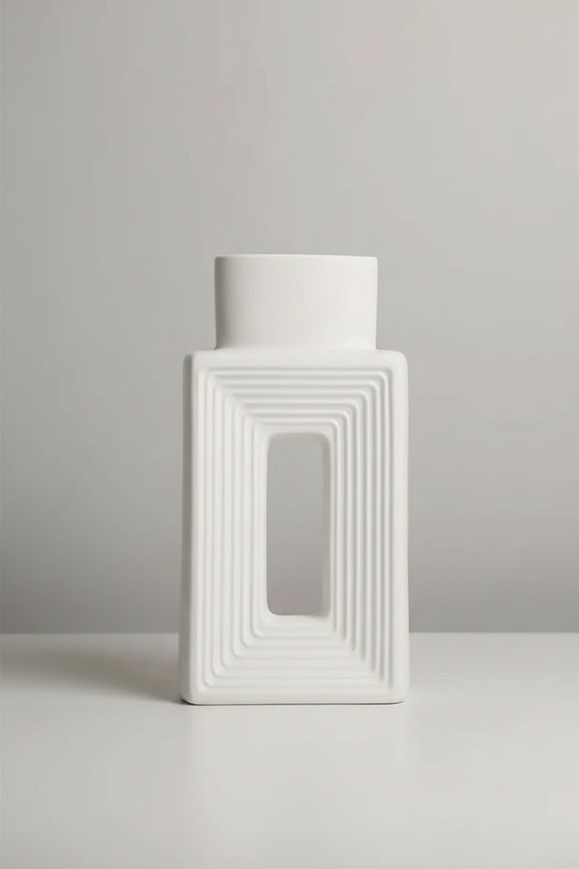 A white rectangular ceramic vase with concentric square ridges and a central rectangular cutout, shown on a beige background with a small text overlay detailing its dimensions.