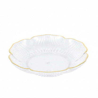 White glass bowl with gold rim on a white background