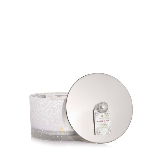 Candle with a decorative lid on a white background