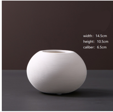 White ceramic vase on a dark background with measurements displayed.